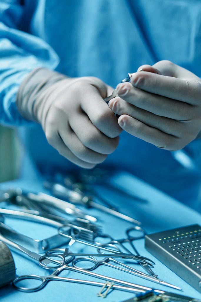 a person holding silver medical tool